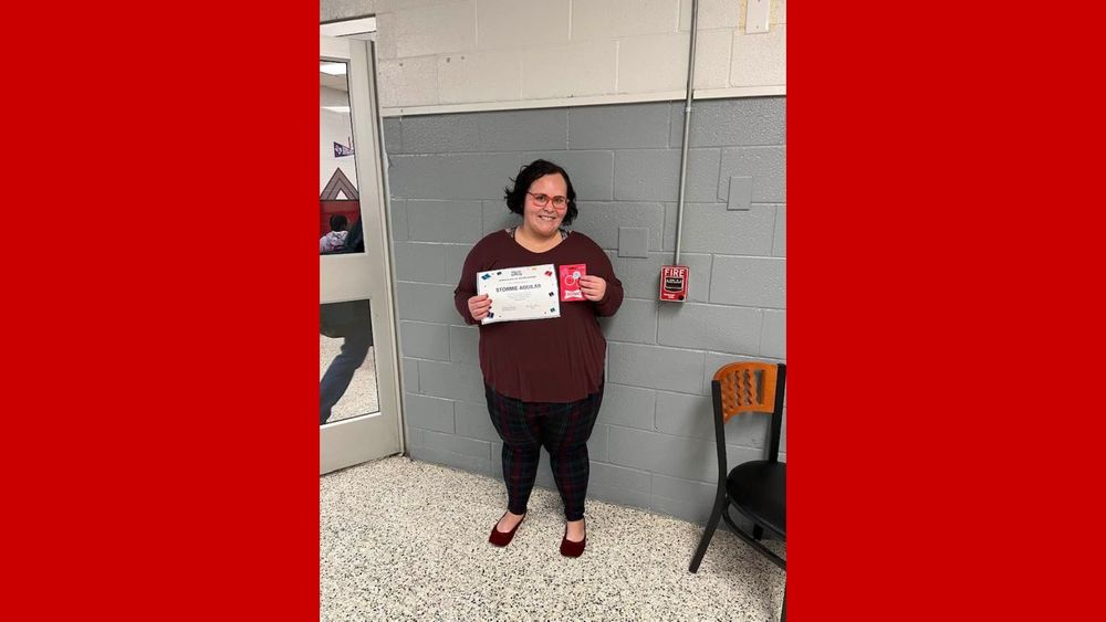 ms. aguilar holding a certificate and sonic gift card